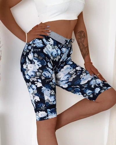 Blue women's 3/4 length shorts with floral pattern - Clothing