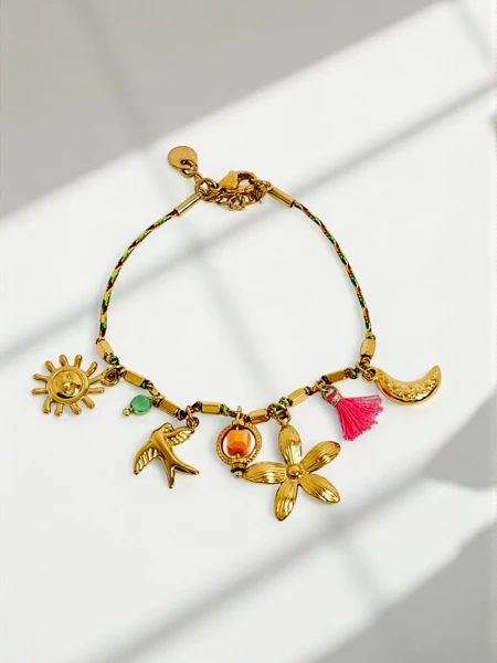 Callisto bracelet with charms with a sun, bird and flower motif