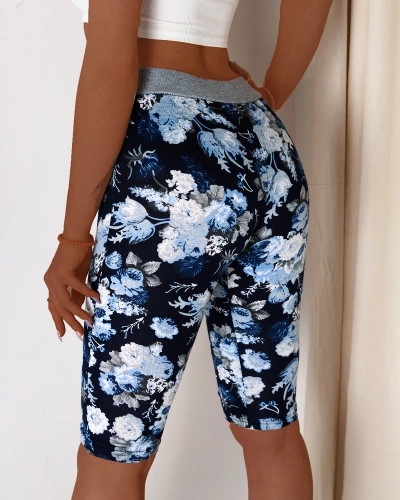 Blue women's 3/4 length shorts with floral pattern - Clothing